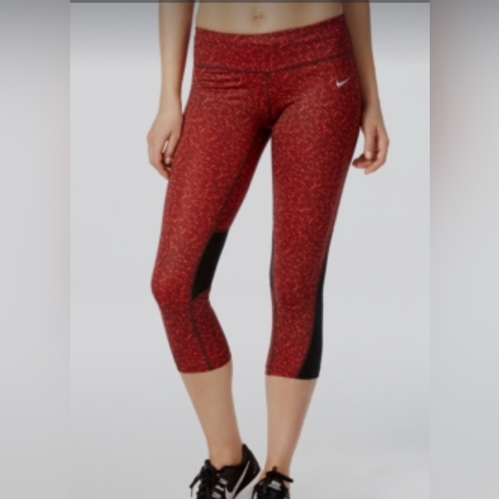 Nike Dri-FIT capri leggings with a red and black pattern and mesh panels size M